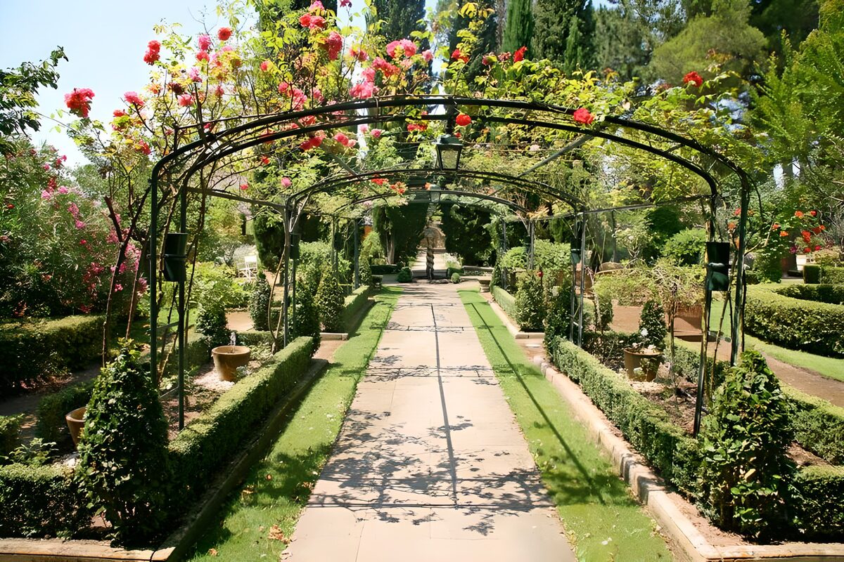 WCUK77296: View through roses arch into French garden  version 3
