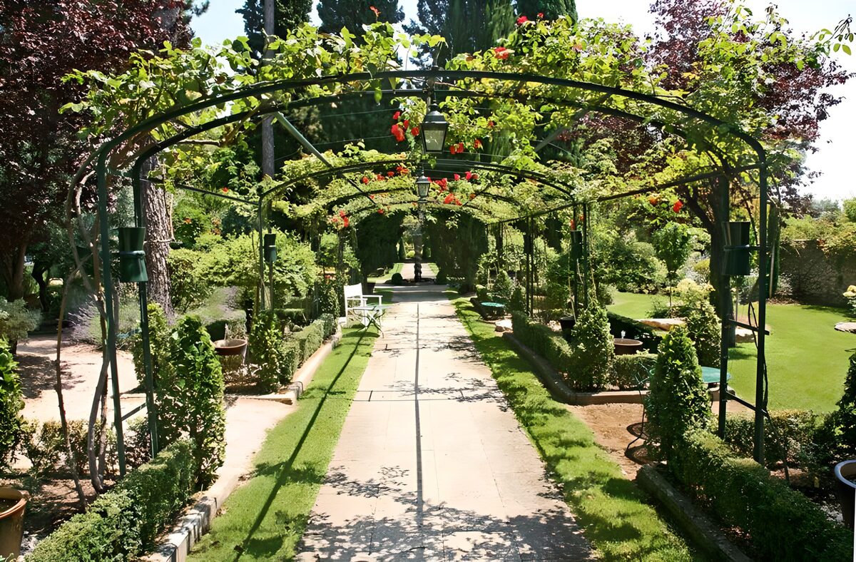 WCUK54923: View through rose arch in French garden version 3