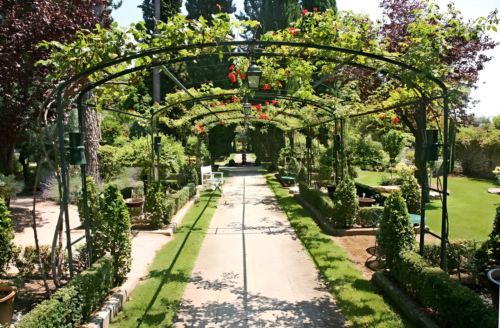 WCUK54923: View through rose arch in French garden version 3