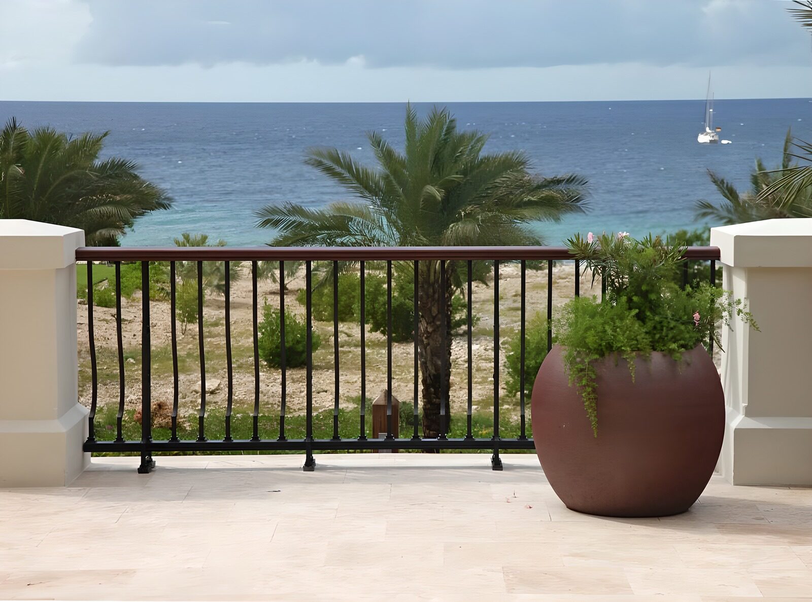 WCUK48005: Flowerpot with plant with a view over the Caribbean and catmaran