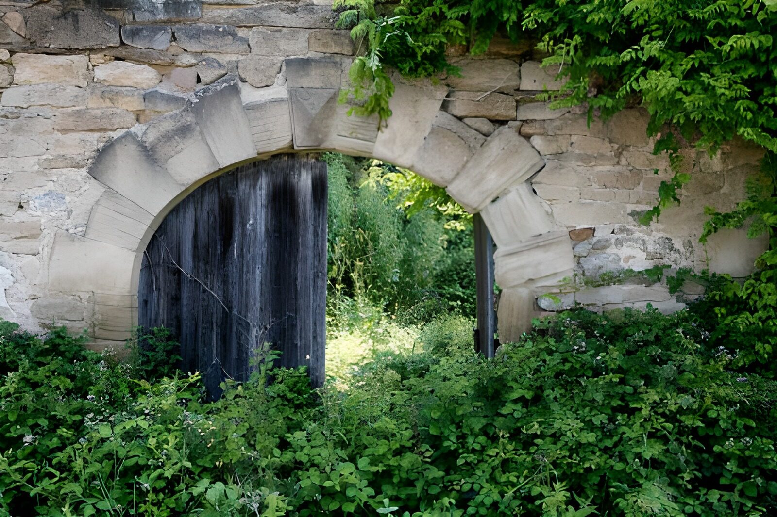 WCUK71103: Door in gate with wall and green foliage 1