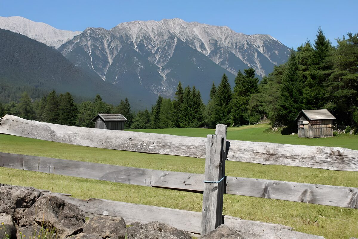 WCUK12578: Stables behind gate in alpine meadow