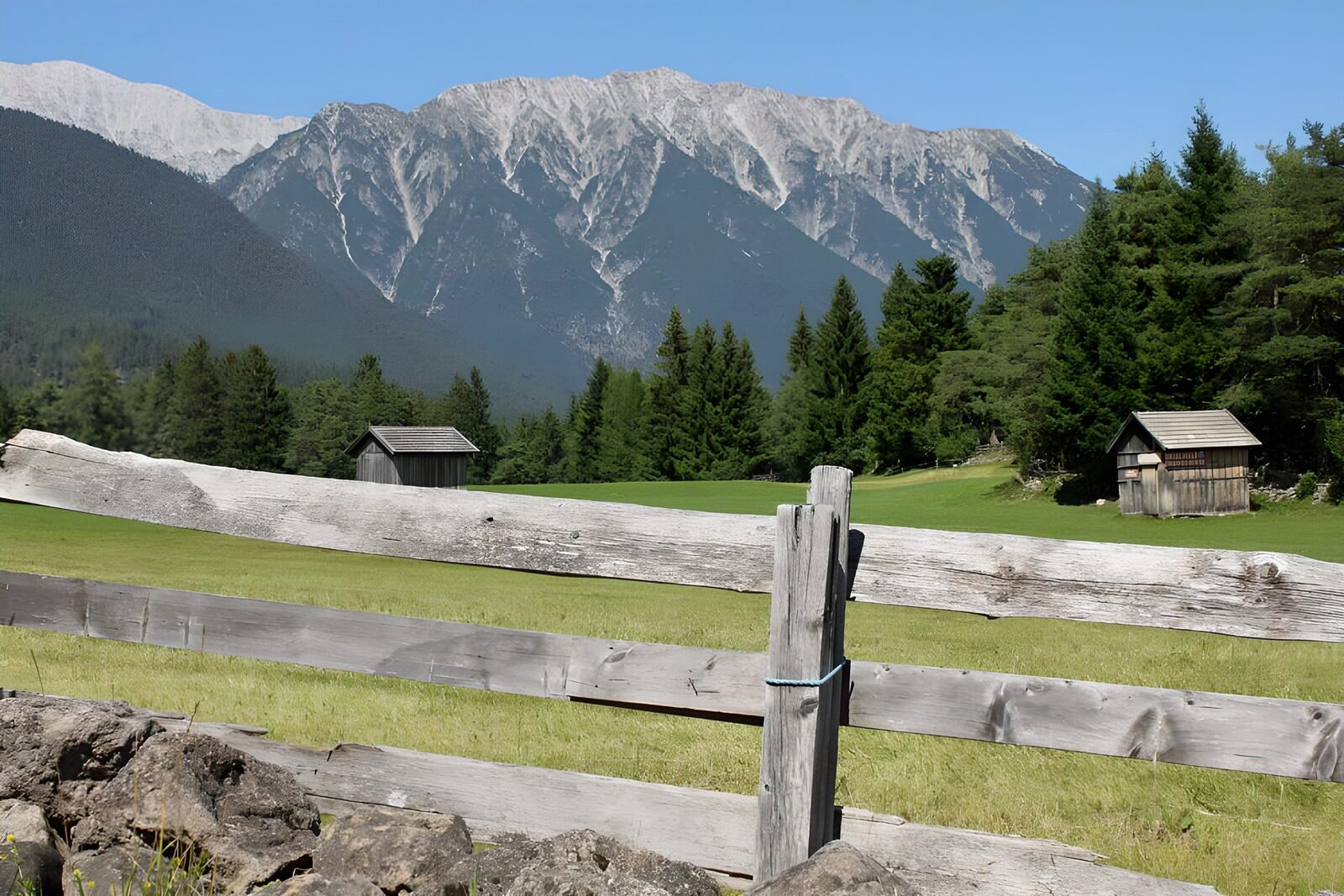 WCUK12578: Stables behind gate in alpine meadow