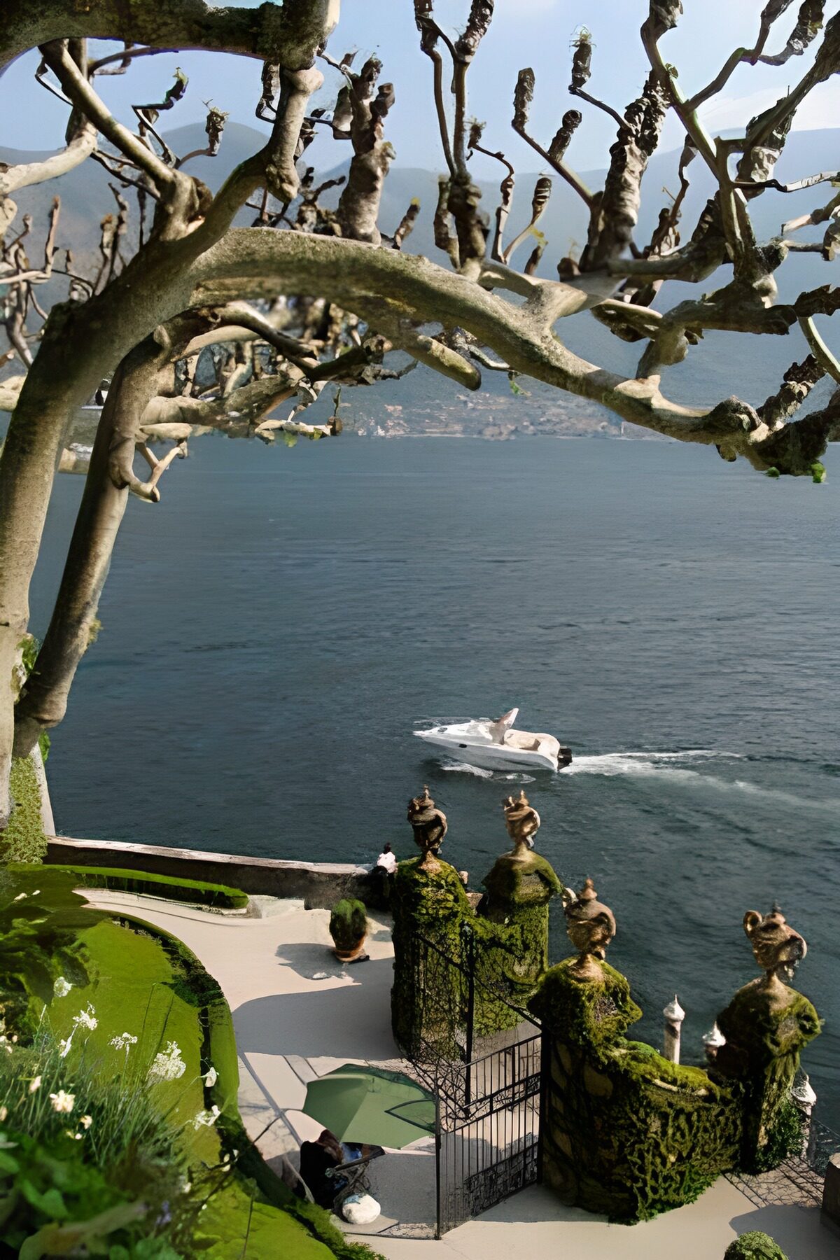 WCUK69173: View over lake with a view through trees with speedboat on the water