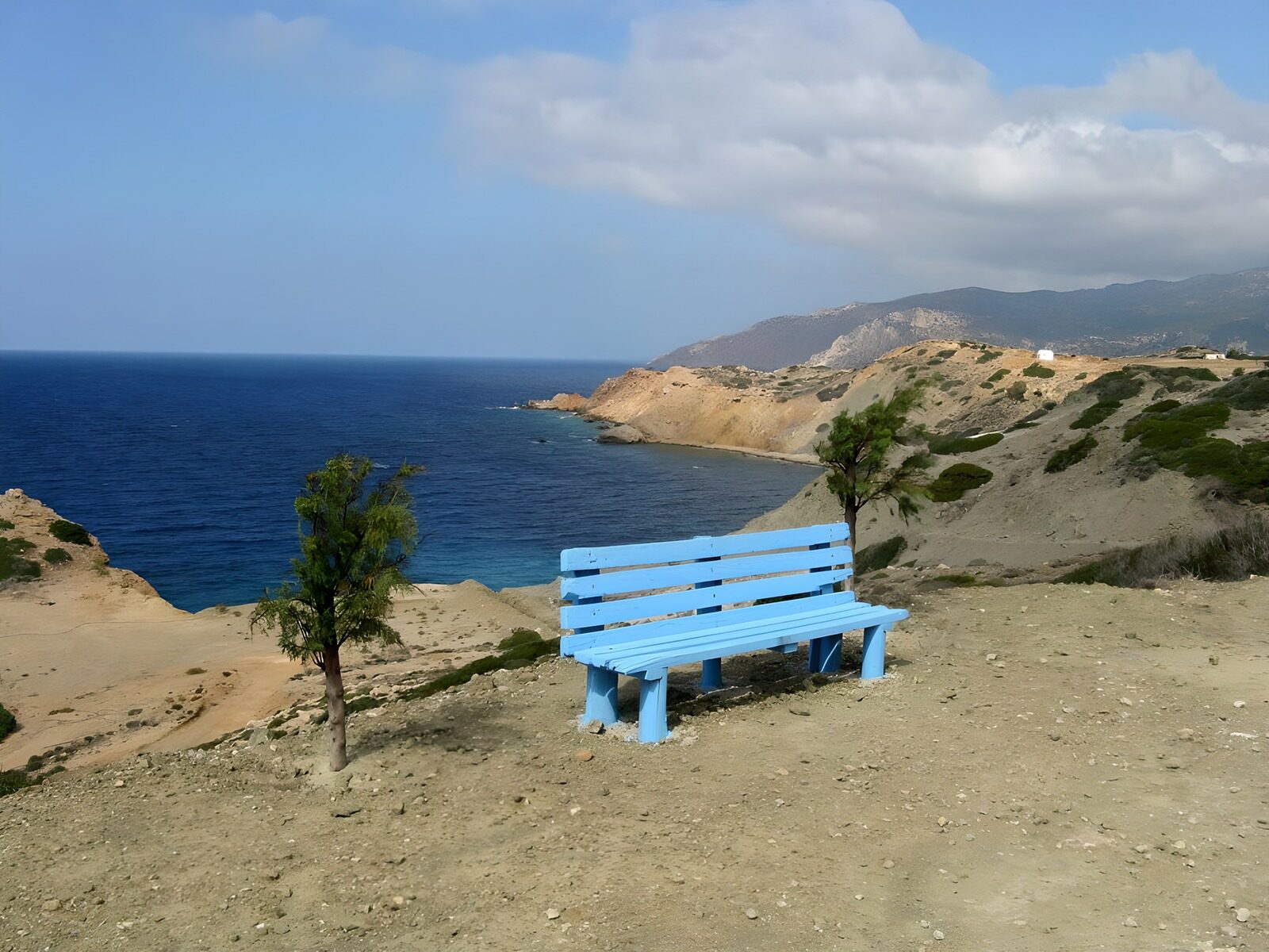 WCUK51054: Blue bench with view on rocks in the sea